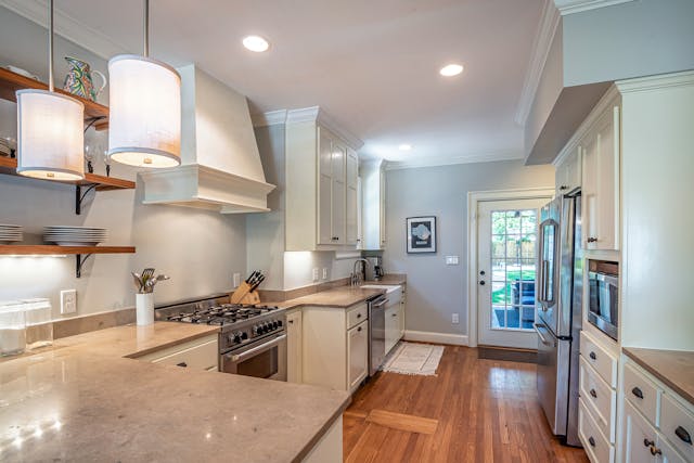 a-light-blue-and-white-kitchen-with-modern-appliances