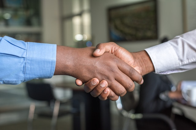investor-and-property-manager-shaking-hands-over-desk-1 investor-and-property-manager-shaking-hands-over-desk-1