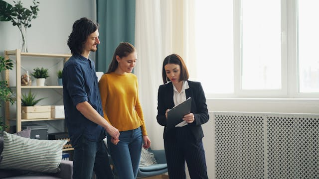 A-landlord-showing-tenants-information-on-a-clipboard A-person-showing-tenants-information-on-a-clipboard