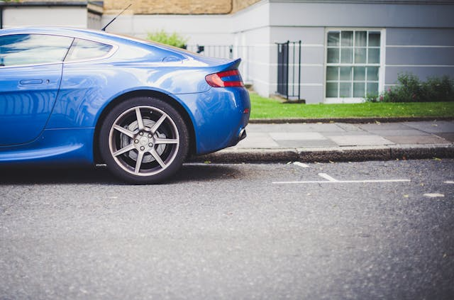 a-blue-car-parked-in-front-of-a-building a-blue-car-parked-in-front-of-a-building