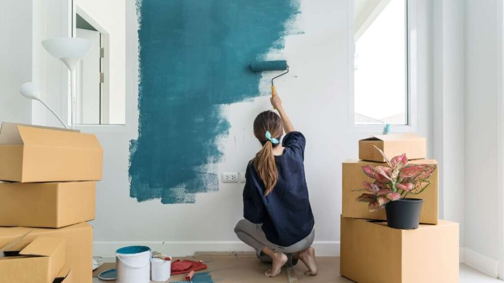 person-painting-a-wall-blue-1024x576