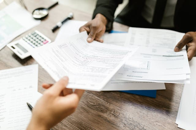 two-people-looking-over-tax-forms