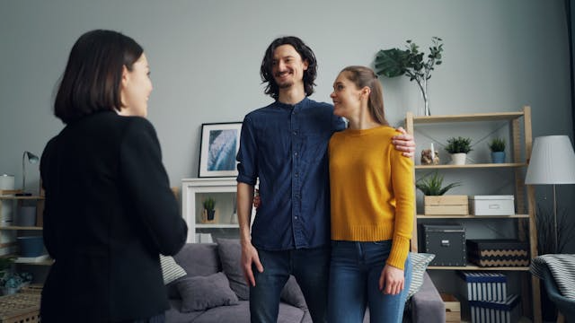 two-prospective-tenants-speaking-with-a-landlord
