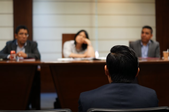 a-person-sitting-through-an-eviction-hearing-in-court