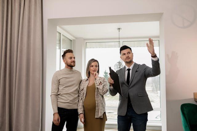 person-conducting-a-property-tour-to-two-prospective-tenants person-conducting-a-property-tour-to-two-prospective-tenants