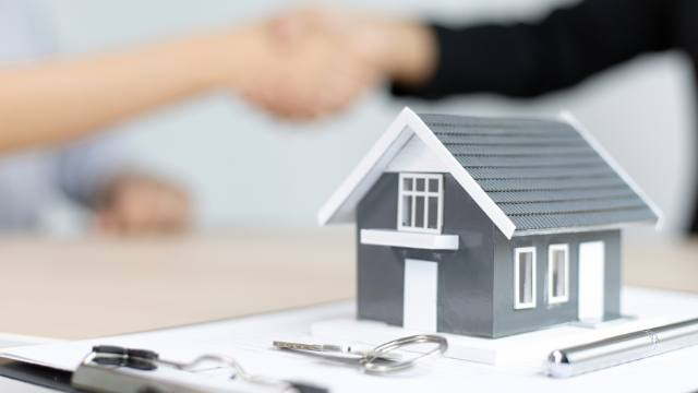 a-home-figurine-on-a-purchasing-contract