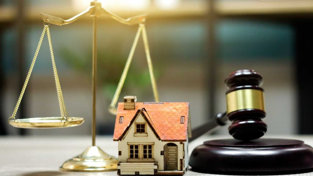a-legal-balance-home-figurine-and-a-judges-gavel-on-a-table-1024x576