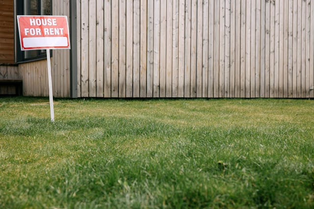 a-for-rent-sign-in-a-front-yard a-for-rent-sign-in-a-front-yard
