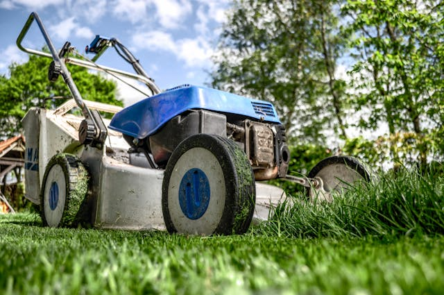a-blue-lawn-mower-cutting-grass
