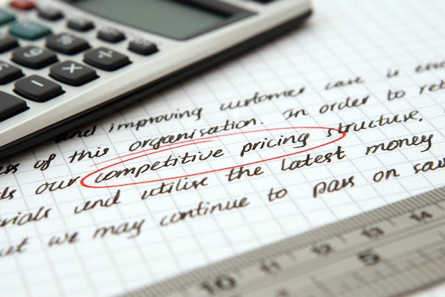 a-calculator-on-a-document-with-the-words-competitive-pricing-circled-in-red