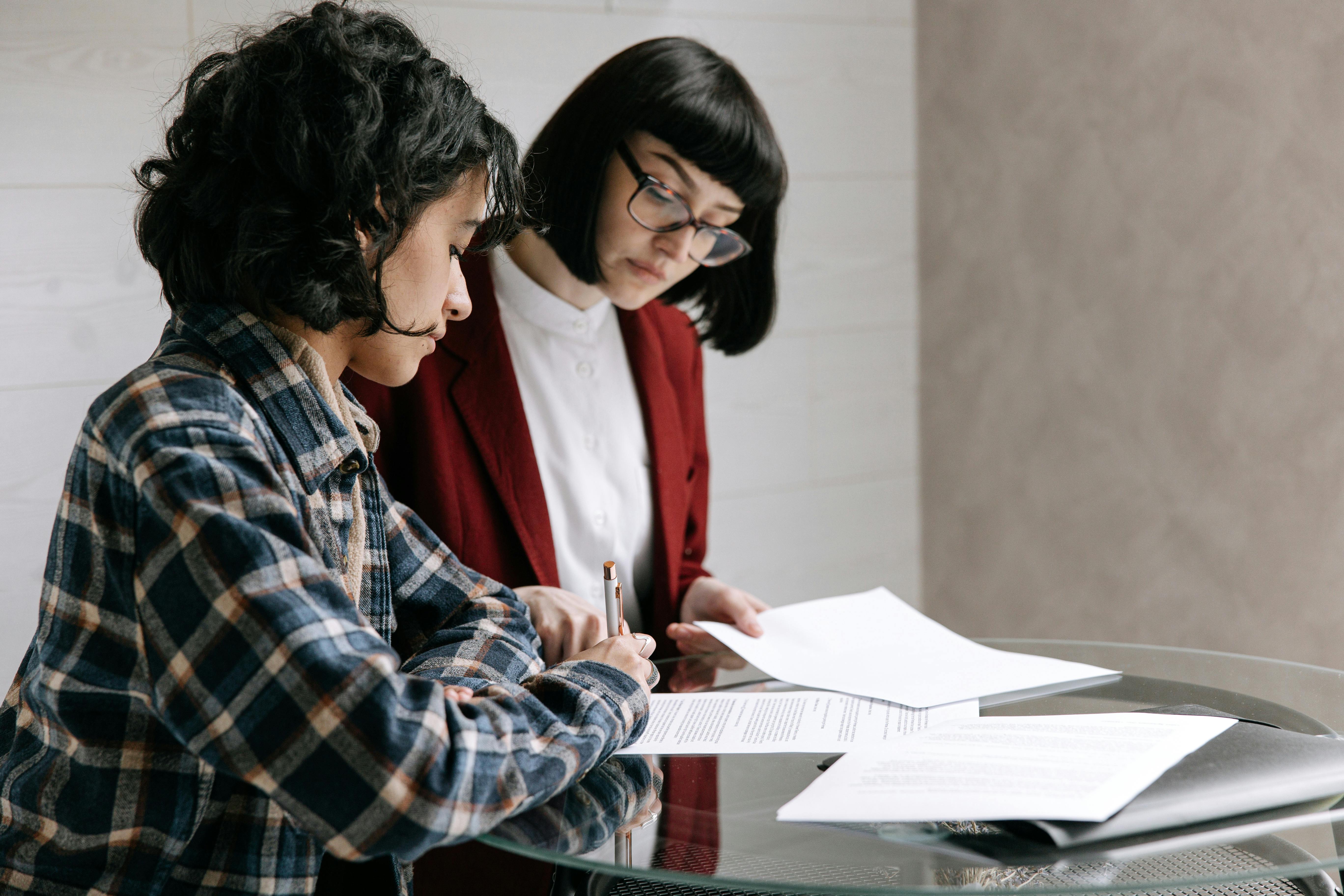 pexels-ivan-s-8962381 women looking over documents