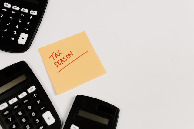 an-orange-sticky-note-with-the-words-tax-seasons-written-in-red an-orange-sticky-note-with-the-words-tax-seasons-written-in-red