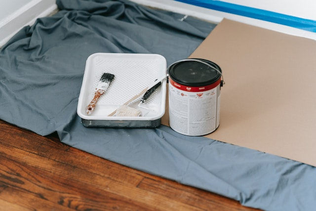 blue-tarp-with-paint-tray-can-and-rollers-the-prep-for-wall-painting blue-tarp-with-paint-tray-can-and-rollers-the-prep-for-wall-painting