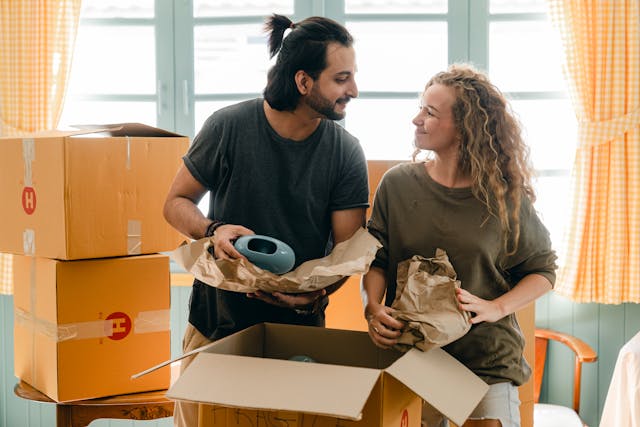 a couple unpacking moving boxes