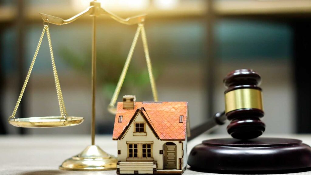 a legal balance home figurine and a judges gavel on a table