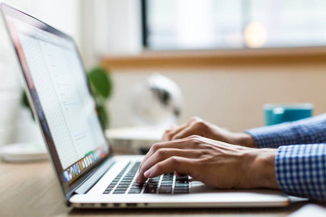 a person typing something on a laptop