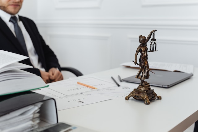 interior of a lawyers office with a a status of lady justice on the desk