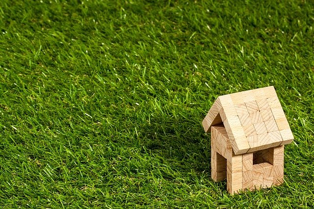 a little home figurine on grass